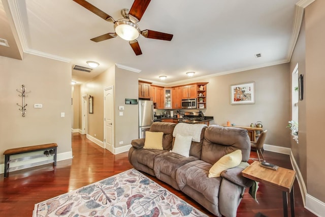 living room with a ceiling fan, ornamental molding, baseboards, and dark wood-style flooring