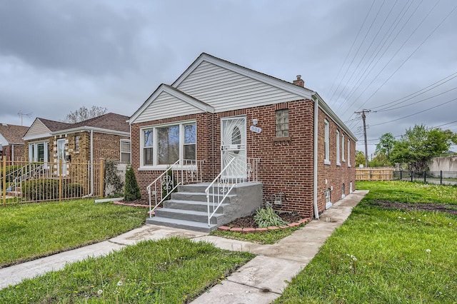 bungalow-style house featuring fence, a front lawn, a chimney, and brick siding