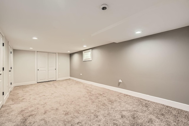 basement with baseboards, recessed lighting, and light colored carpet