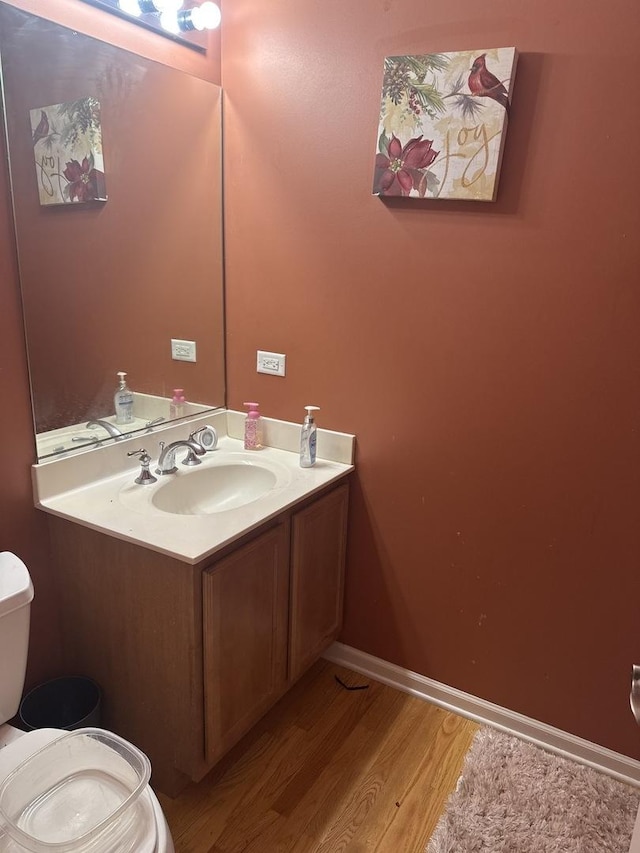 5588 Cambridge Way, Hanover Park, IL 60133 - bathroom featuring vanity, toilet, baseboards, and wood finished floors