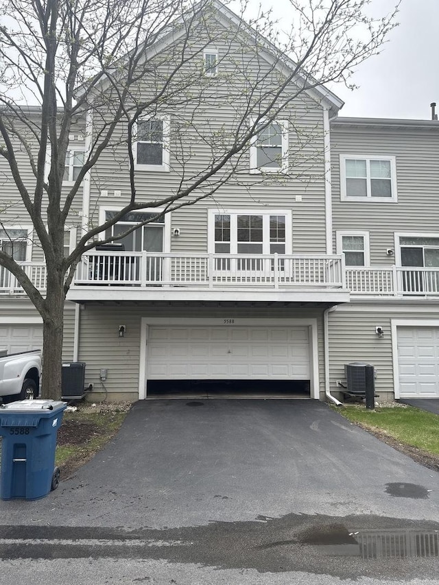 5588 Cambridge Way, Hanover Park, IL 60133 - view of front facade with an attached garage, central AC, and driveway