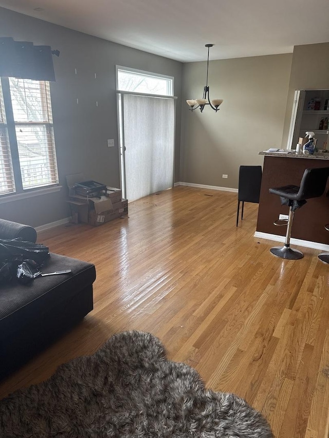5588 Cambridge Way, Hanover Park, IL 60133 - living room featuring light wood-style floors, a chandelier, and baseboards