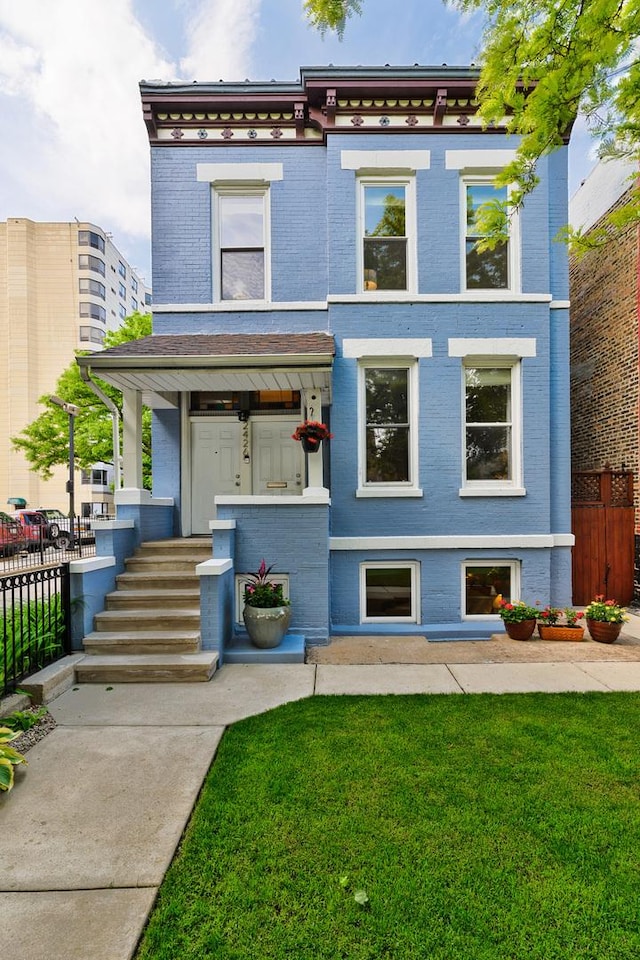 2426 W Mclean Ave, Chicago, IL 60647 - view of front of property featuring brick siding and a porch