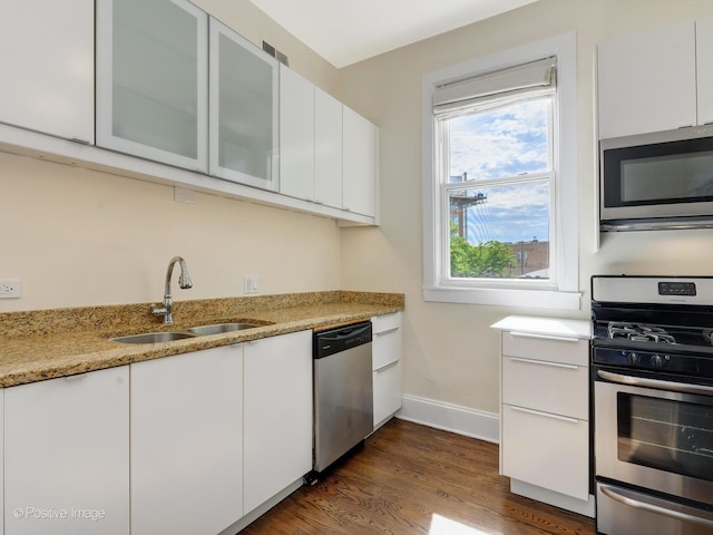 2426 W Mclean Ave, Chicago, IL 60647 - kitchen featuring appliances with stainless steel finishes, a sink, white cabinets, and baseboards