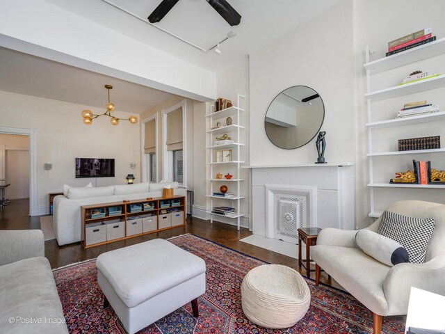 2426 W Mclean Ave, Chicago, IL 60647 - living room with wood finished floors, built in shelves, baseboards, rail lighting, and a chandelier