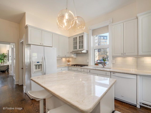 2426 W Mclean Ave, Chicago, IL 60647 - kitchen with white appliances, a sink, tasteful backsplash, dark wood finished floors, and light stone countertops