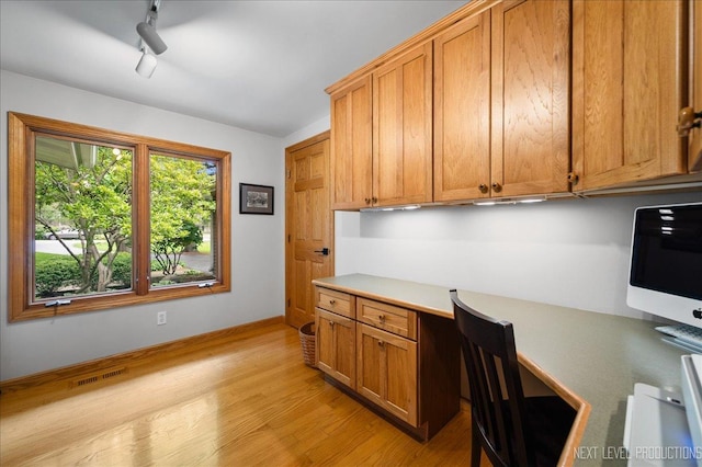 6N198 Old Homestead Rd, Saint Charles, IL 60175 - unfurnished office featuring built in desk, light wood finished floors, track lighting, and baseboards