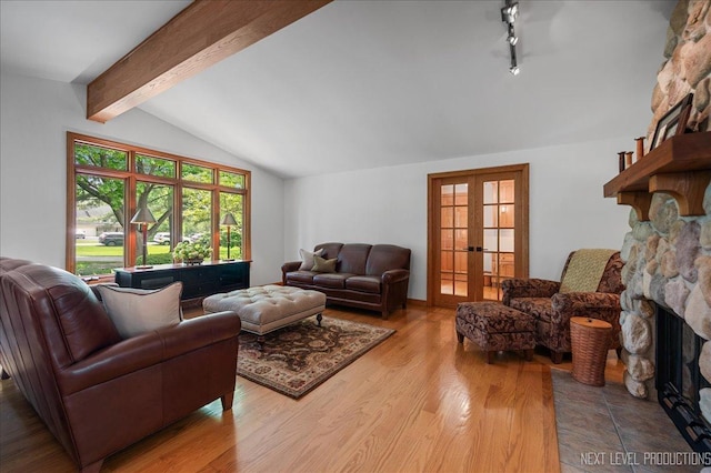 6N198 Old Homestead Rd, Saint Charles, IL 60175 - living room featuring a stone fireplace, french doors, wood finished floors, and rail lighting