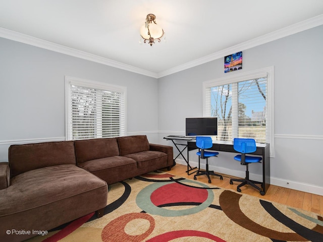 living area with crown molding, a healthy amount of sunlight, and wood finished floors