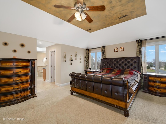 bedroom featuring baseboards, ensuite bath, ceiling fan, visible vents, and carpet floors
