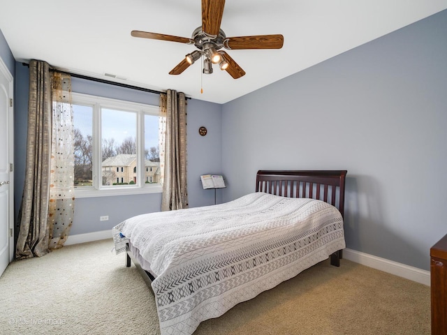 carpeted bedroom featuring ceiling fan, baseboards, and visible vents