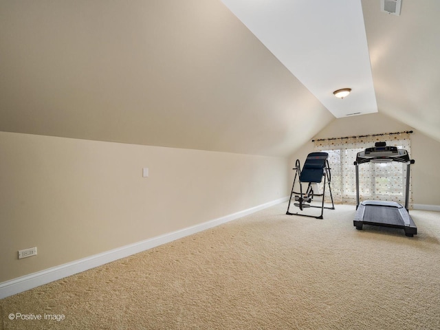 workout room with vaulted ceiling, carpet, and baseboards