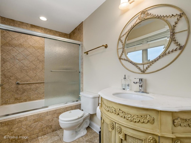 full bath featuring toilet, tiled shower / bath, tile patterned floors, baseboards, and vanity
