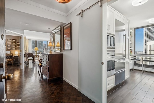 hall featuring ornamental molding and baseboards