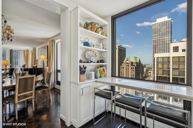 kitchen featuring healthy amount of natural light, a view of city, open shelves, floor to ceiling windows, and parquet flooring