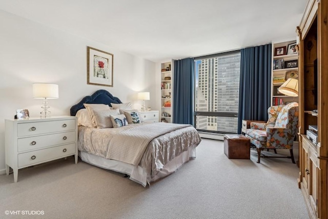 bedroom featuring light carpet, expansive windows, and baseboard heating