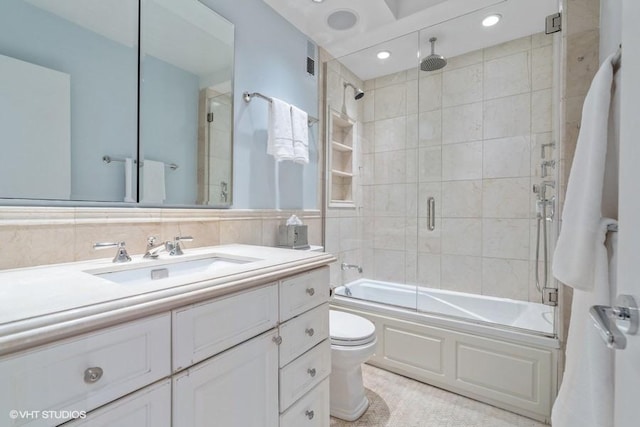 bathroom with a combined bath / shower with rainfall shower, toilet, vanity, and recessed lighting