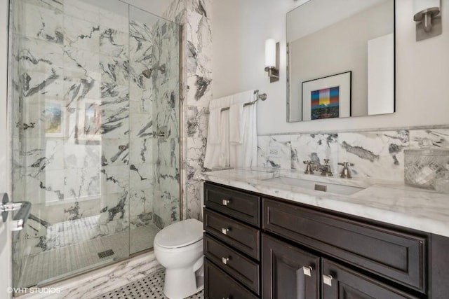 full bath featuring a marble finish shower, toilet, vanity, and tile walls