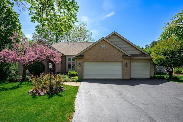 638 Roxbury Rd, Rockford, IL 61107 - view of front of house with brick siding, driveway, a front lawn, an attached garage, and a shingled roof