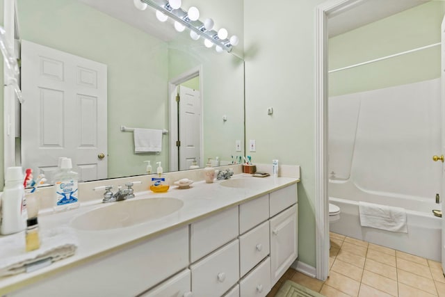 638 Roxbury Rd, Rockford, IL 61107 - bathroom featuring toilet, tile patterned floors, double vanity, and shower / tub combination