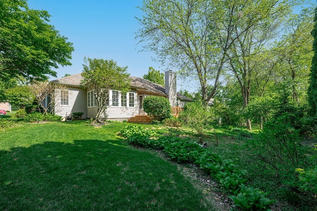 638 Roxbury Rd, Rockford, IL 61107 - rear view of property with a chimney and a yard