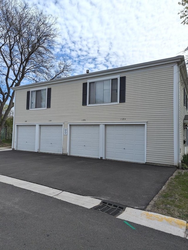 garage with aphalt driveway