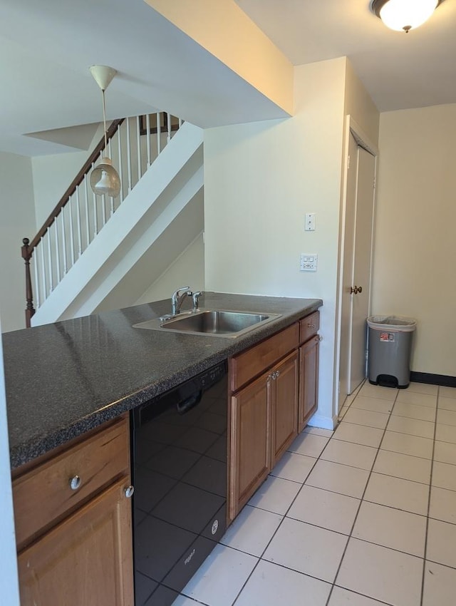 kitchen with dishwasher, a sink, dark countertops, brown cabinets, and light tile patterned floors