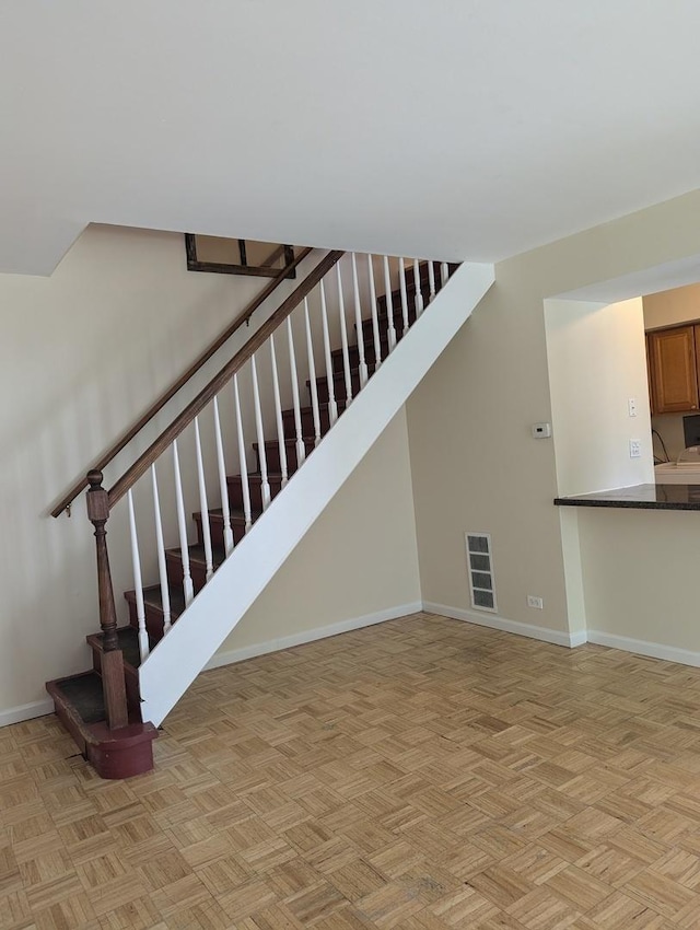stairway with visible vents and baseboards