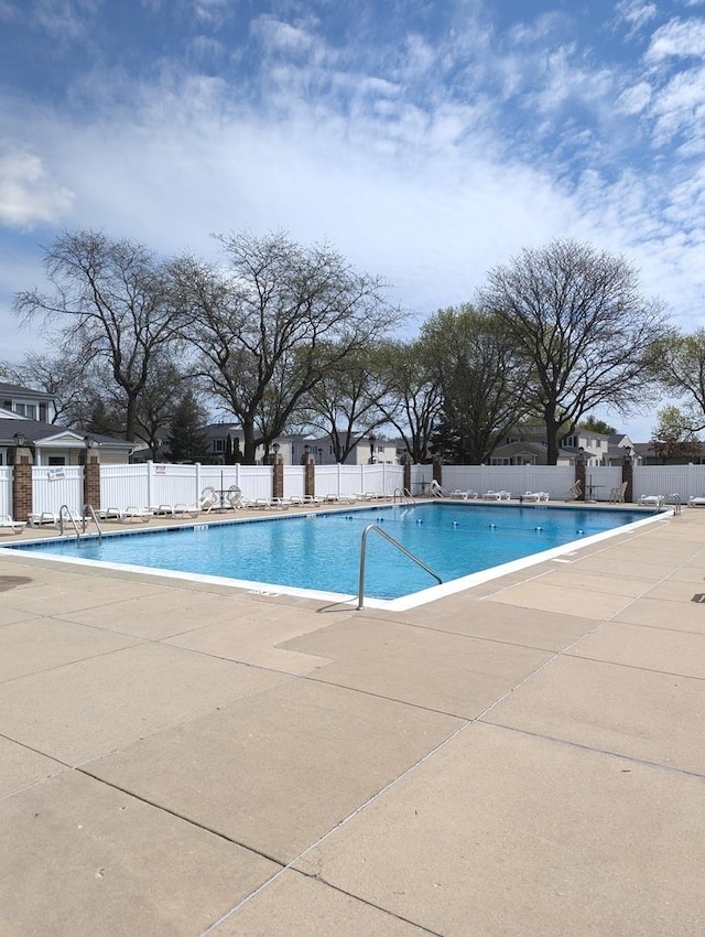 pool featuring fence and a patio