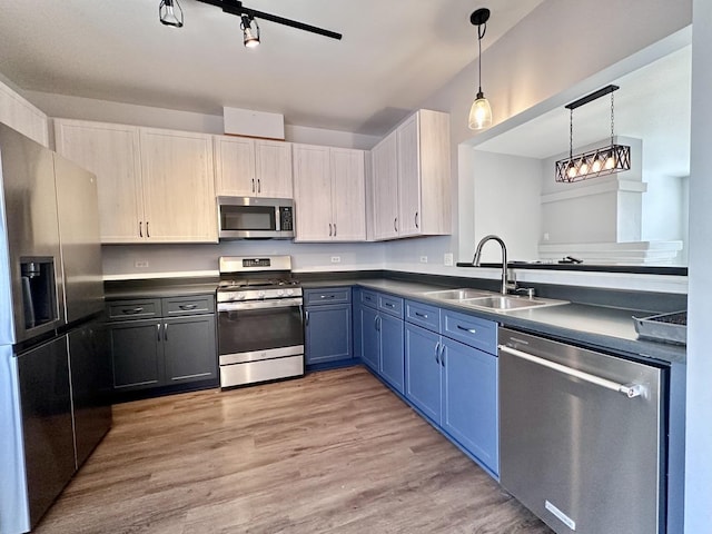2278 Twilight Dr, Aurora, IL 60503 - kitchen featuring a sink, appliances with stainless steel finishes, blue cabinetry, hanging light fixtures, and light wood-style floors