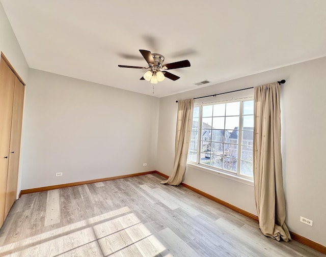 2278 Twilight Dr, Aurora, IL 60503 - spare room featuring a ceiling fan, light wood-style floors, visible vents, and baseboards