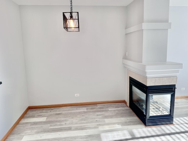 2278 Twilight Dr, Aurora, IL 60503 - interior space with baseboards, a tiled fireplace, and light wood-style floors