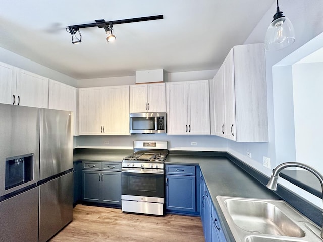 2278 Twilight Dr, Aurora, IL 60503 - kitchen featuring a sink, dark countertops, light wood-type flooring, appliances with stainless steel finishes, and blue cabinets