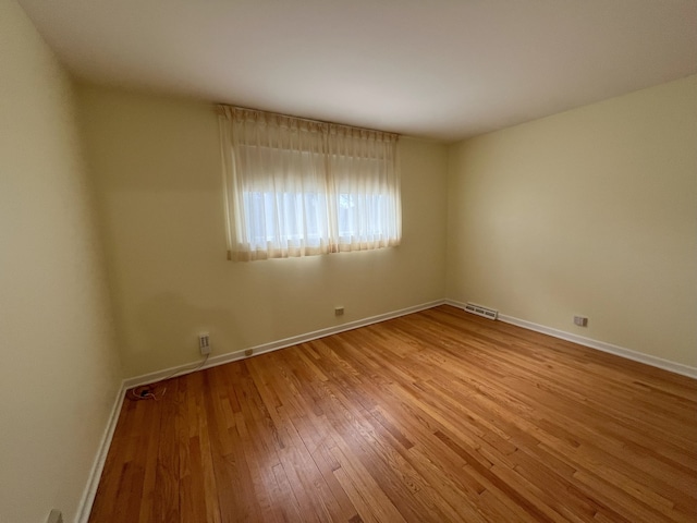 7924 Tripp Ave, Skokie, IL 60076 - empty room featuring baseboards, wood-type flooring, and visible vents
