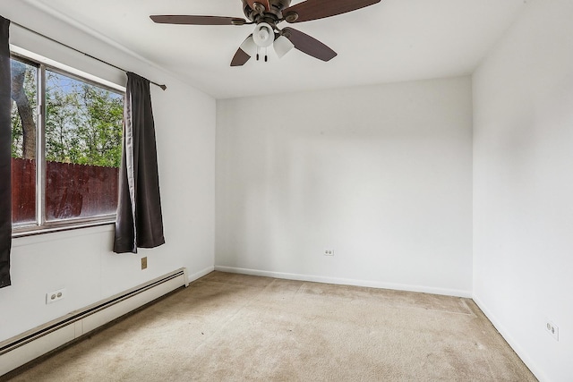 empty room with ceiling fan, light carpet, baseboards, and a baseboard heating unit