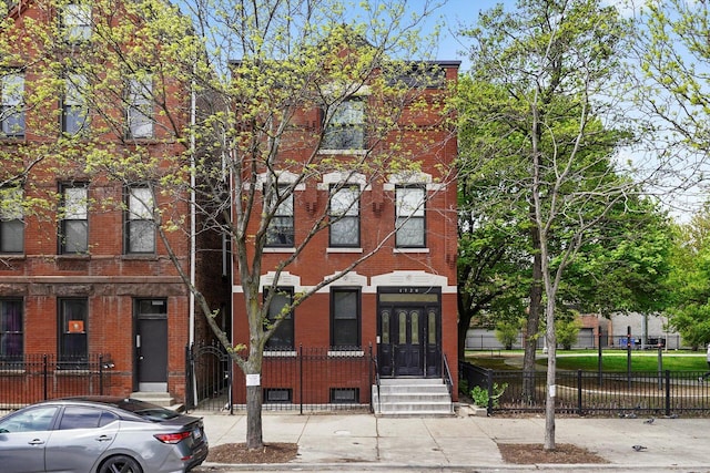 multi unit property with brick siding and fence