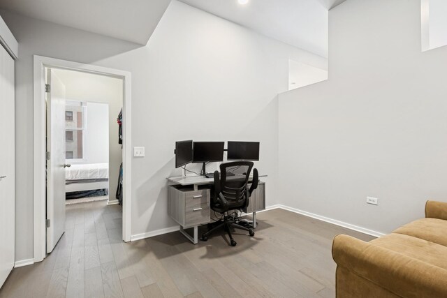 office space featuring wood finished floors, baseboards, and recessed lighting