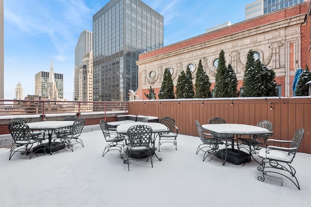 view of patio with a city view and outdoor dining area