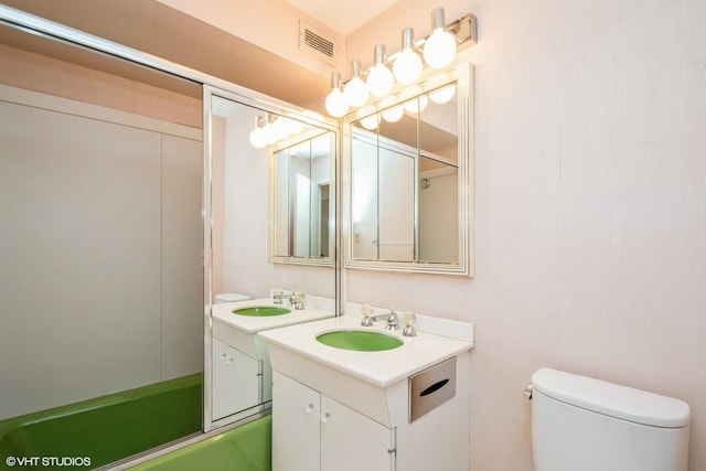 full bath with toilet, combined bath / shower with glass door, and vanity