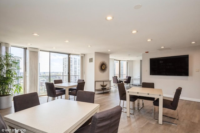 dining room featuring recessed lighting, light wood finished floors, and baseboards