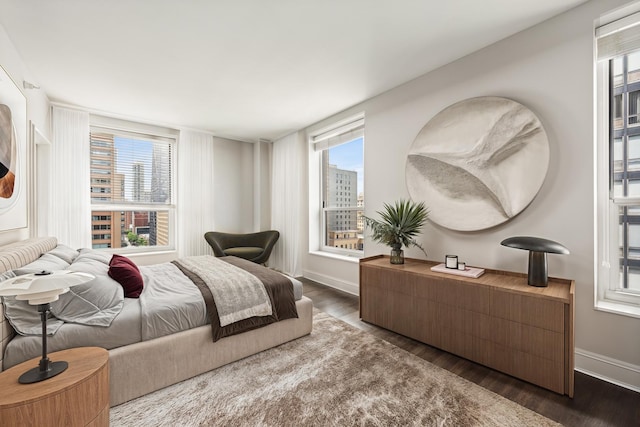 bedroom featuring wood finished floors and baseboards