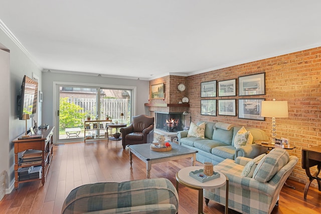 1805 Wildberry Dr Unit C, Glenview, IL 60025 - living room featuring wood-type flooring, brick wall, a fireplace, crown molding, and baseboards