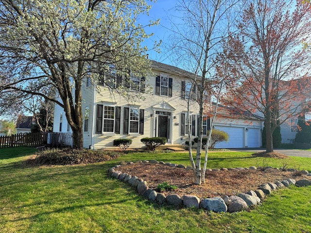 colonial home with fence and a front yard
