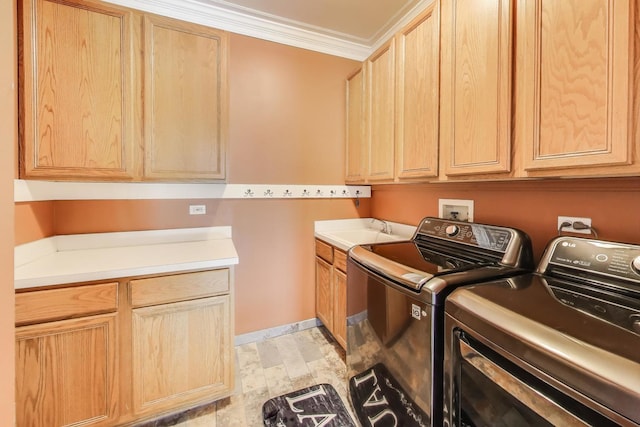 clothes washing area with washer and clothes dryer, crown molding, a sink, and cabinet space