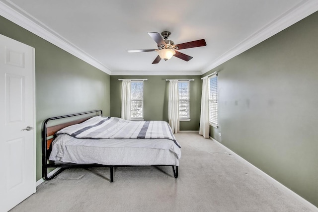 carpeted bedroom with baseboards, ceiling fan, and crown molding
