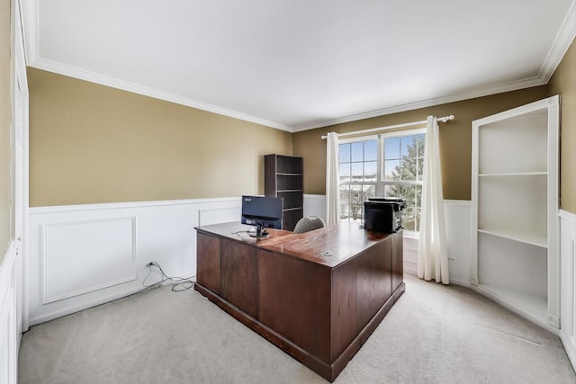 office space featuring wainscoting, ornamental molding, and light carpet