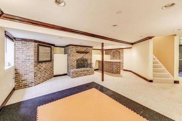 finished below grade area with recessed lighting, carpet, ornamental molding, brick wall, and a fireplace