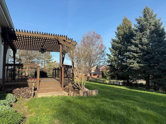 view of yard with a pergola, fence, and a wooden deck