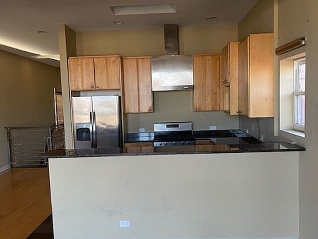 1625 N Halsted St, Chicago, IL 60614 - kitchen with appliances with stainless steel finishes, wall chimney exhaust hood, a peninsula, dark stone counters, and dark wood finished floors