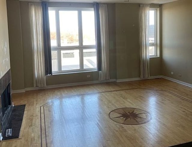 1625 N Halsted St, Chicago, IL 60614 - unfurnished living room featuring wood finished floors, plenty of natural light, and a fireplace with flush hearth